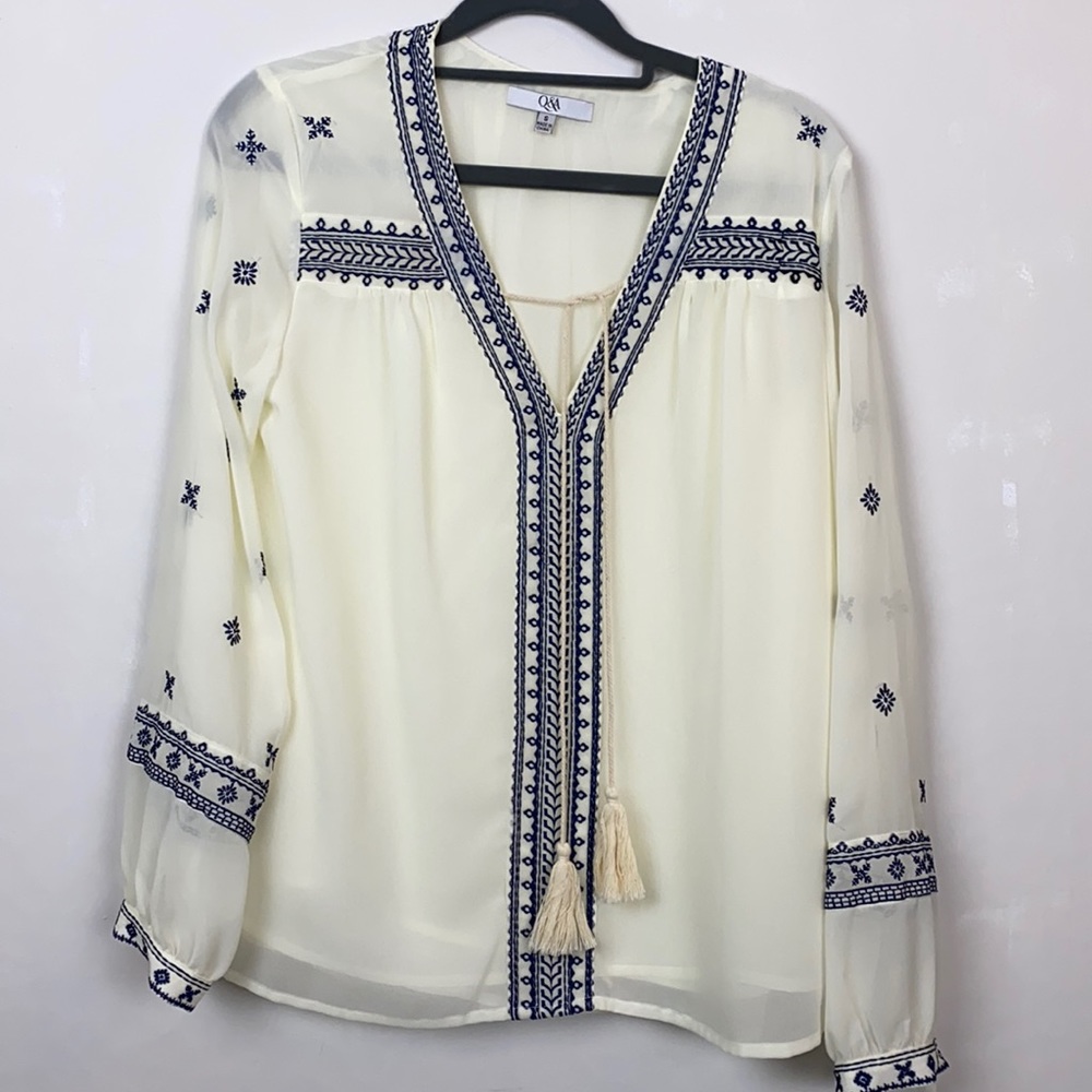 Q&A ladies top in a off white/ cream color with navy trim. Very versatile.